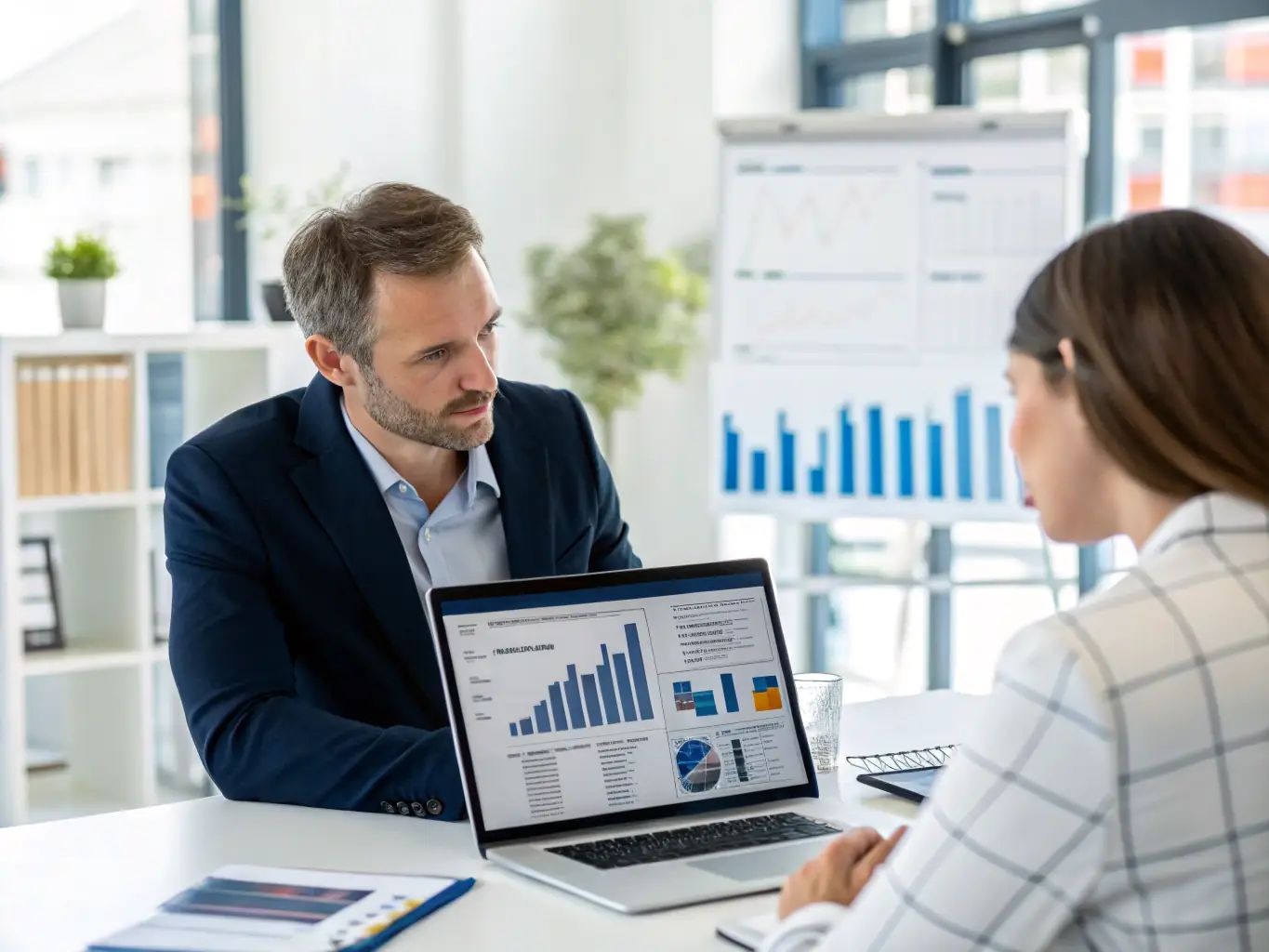 A professional financial advisor is reviewing a client's investment portfolio in a modern office setting, highlighting the benefits of a comprehensive audit.